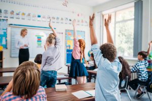 kids-raising-hands-in-class-to-answer-teachers-que-QNK3VQH (1)